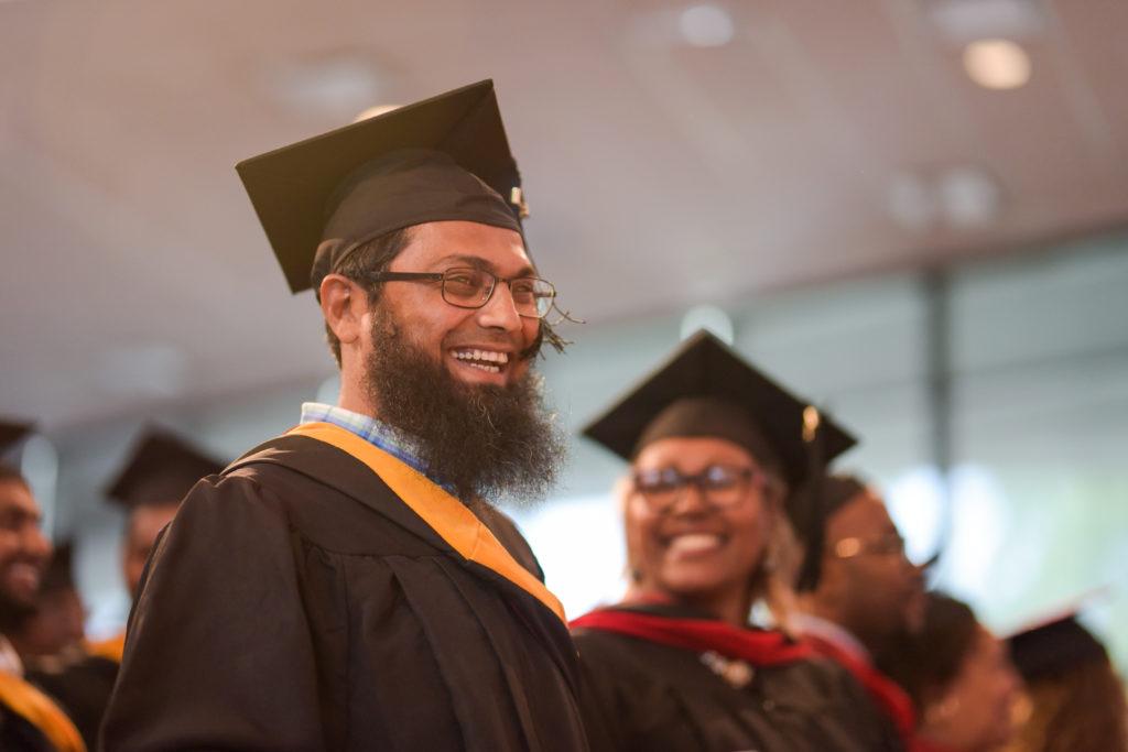 M A Faiyaz Ahmed of India, expresses his feelings after Dr. Michael V. Carter, president of Campbellsville University, confers the Master of Science in Technology and Management degree (MSITM), during the graduation ceremony at Campbellsville University. (Campbellsville University Photo by Joshua Williams)