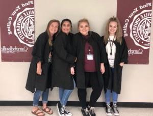 From left, Chloe Sandidge, Kaitlyn Knight, Nancy Aguilar and Kelley Wissing, LaRue County seniors, wear their new smocks and smile for the camera.