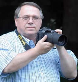 Stan McKinney holding camera