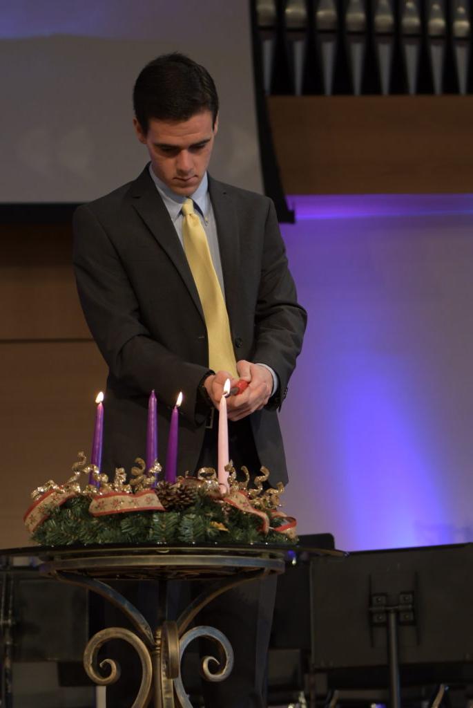 Corbin Harris lights the advent candles during the CU Family chapel service. (CU Photo by Emily Barth) 