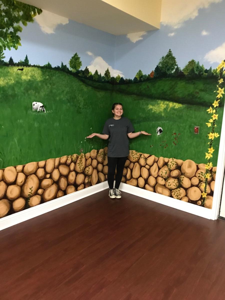 CU art student Whitley Howlett paints mural in assisted living facility in Louisville, Ky.