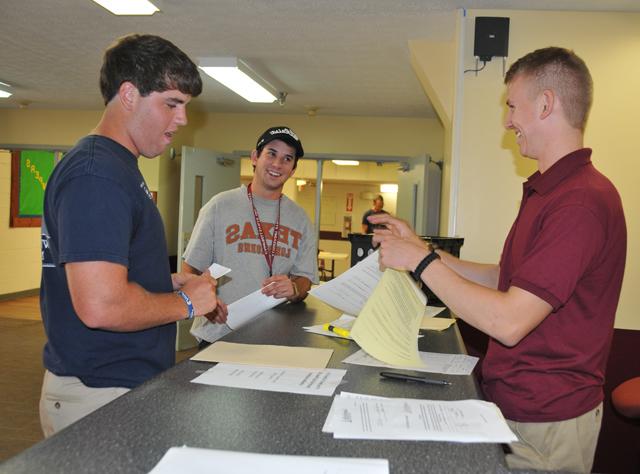 Andrew Jansen, center, a sophomore of Greenbrier, Tenn., and Cody Goodwin, right, a freshman of Portland, Tenn., check into South Hall with Garrett Baker, a senior of Bowling Green, Ky., who serves as a Campbellsville University resident assistant. Jansen and Goodwin are members of the golf team. CU student athletes move in to campus beginning today, Aug. 10. (Campbellsville University Photo by Christina L. Kern)