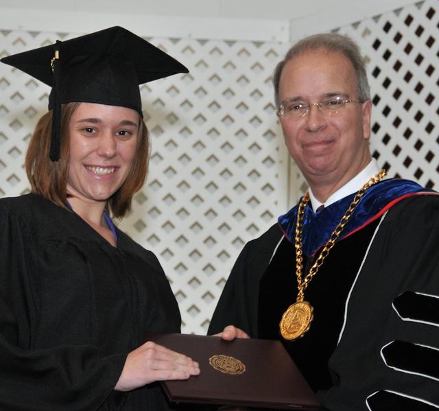 Campbellsville University 2013 graduate Kayla Bradshaw from Greensburg, Ky. receives her diploma from President Michael V. Carter. In her Facebook post right before commencement, she wrote: “I’ve had an amazing experience at Campbellsville University. God blessed me with great professors and friends.” (Campbellsville University Photo by Joan C. McKinney)