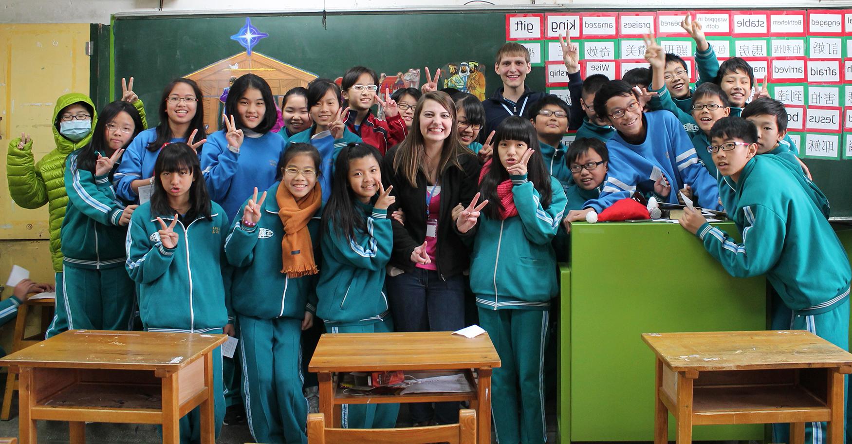  Taiwanese school children gather around CU students Jeremy Cheatham and Bethany Thomaston during their mission trip to Taipei, teaching them about the Nativity Story. (CU Photo provided by Bethany Thomaston)