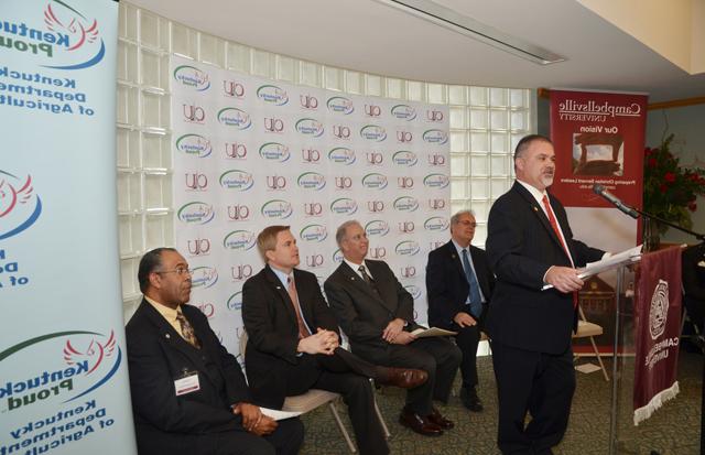 Speaking at the Kentucky Farm to Campus event was from left: Bam Carney, state representative,  51st District, with others in back from left: Tony Young, mayor of City of Campbellsville; Dr.  Michael V. Carter, president of Campbellsville University; James Comer, commissioner, Kentucky Department of Agriculture; and Dr. Joseph Owens, chair of the CU Board of Trustees. (Campbells- ville University Photo by Joan C. McKinney)