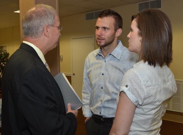 Eric Gilbert, center, will be the chapel speaker at 10 a.m. Wednesday, Sept. 4. He talks with Dr. Michael V. Carter, CU president, at the recent Church Relations Council meeting. At left is his wife Mandy. (Campbellsville University Photo by Joan C. McKinney)