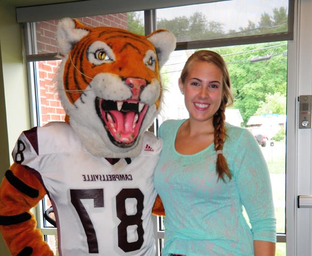 Hannah Sadler of Taylor County poses with the Tiger mascot Claws. (Campbellsville University Photo by Ellie McKinley)