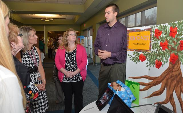 Senior Jonas Bohm, left, of Germany explains his poster to from left: Lindsey Hammons and Kristi Jenkins, NEA observer and teacher from Somerset High School, on the state NCATE team. (Campbellsville University Photo by Joan C. McKinney)