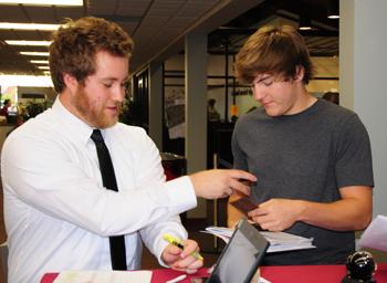  Jordan Netherland, residence hall director of South Hall West, helps Mitchell Claunch of Tuscumbia, Ala., during  LINC. (Campbellsville University Photo by Ellie McKinley)