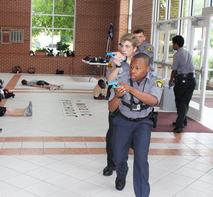 Keenan Wright from Cincinnati Police Explorers acts as a police officer in a real-life shootout simulation by Kentucky Law Enforcement Explorer Academy at Campbellsville University. (Campbellsville University Photo by Joshua Williams)