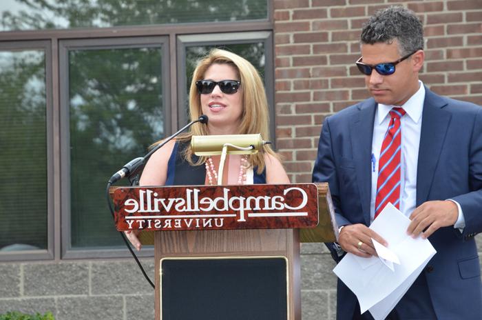 Stephanie Montgomery, right, talks about her experiences at and love for Campbellsville University and her mother during the dedication of the Ella Louise “Lou” Montgomery academic building at the Louisville Education Center. With her is her brother, Kris, who also spoke of her mother's love for education and always encouraging them to be the best they could be. (Campbellsville University Photo by Joan C. McKinney)