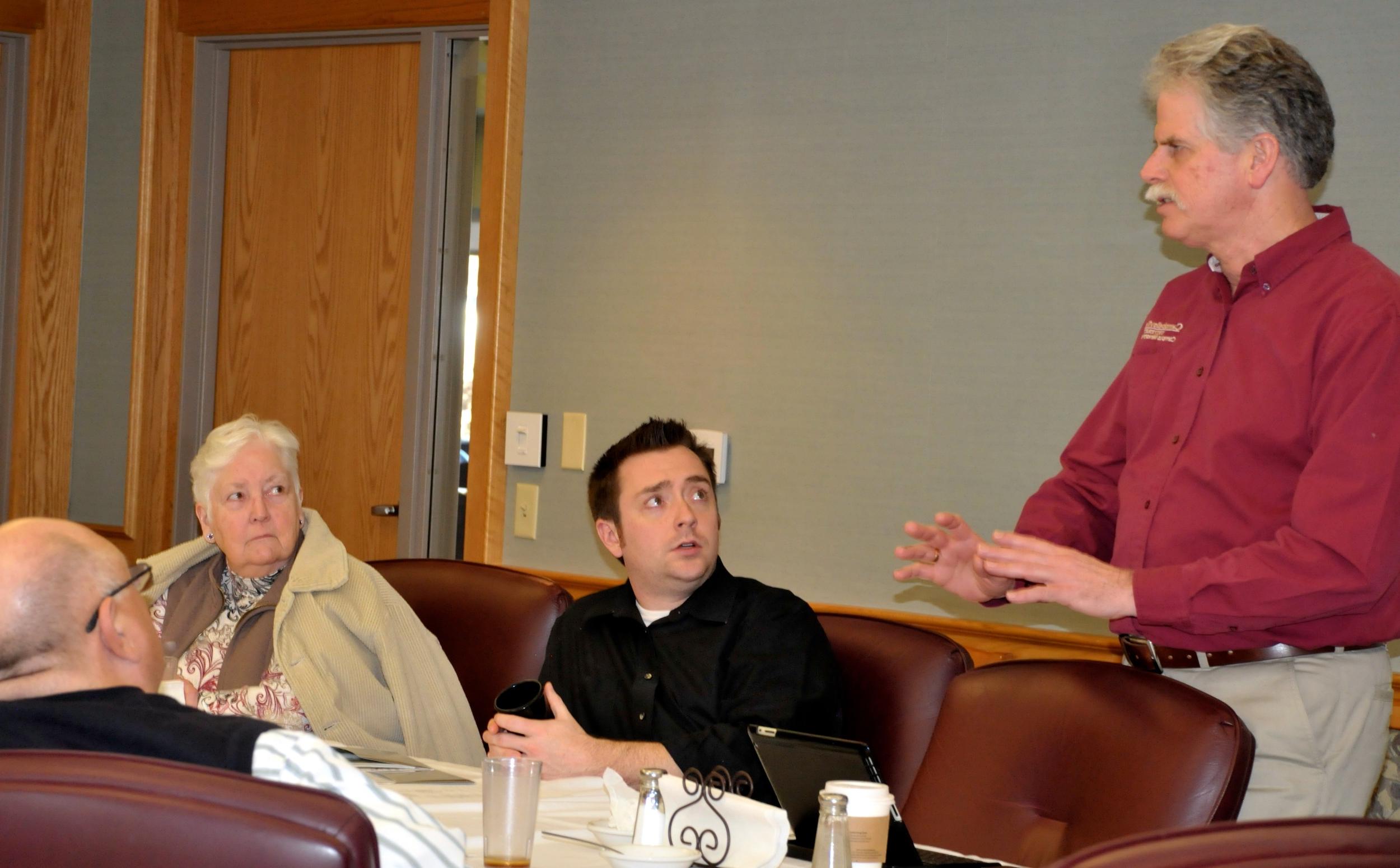 The Rev. Ed Pavy, Director, Campus  Ministries, speaks to the CU Church  Relations Council executive committee  group. Rev. Kenny Rager, Mrs. Grace  Bristow and Rev. Jay Hatfield look on.  (CU Photo by Linda Waggener)