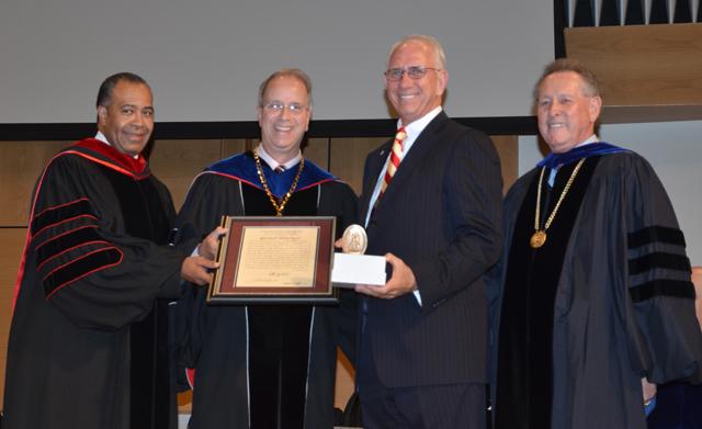 r. Larry Noe, second from left, receives the Algernon Sydney Sullivan Award at the graduate commencement from Dr. Frank Cheatham, vice president for academic affairs, left; Dr. Michael V. Carter, CU president; and Dr. Joe Owens, chair of the CU Board of Trustees. (Campbellsville University Photo by Joan C. McKinney)