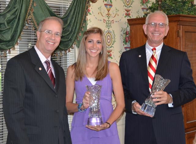 Dr. Larry Noe, left, and Jordan Cornett receive glass vases at the home of Dr. Michael V. Carter, president, on in honor of their winning the Algernon Sydney Sullivan Award at Campbellsville University. (Campbellsville University Photo by Joan C. McKinney)