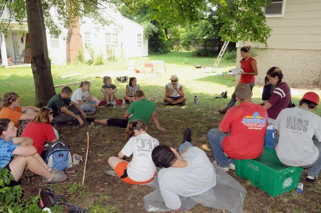 Laura Hatfield, administrative assistant for KHO and summer camp manager, reads a devotion to her group of volunteers from Brainerd United Methodist Church in Chattanooga, Tenn., First United Methodist Church in Panama City, Fla., and Mt. Vernon Baptist Church in Boone, N.C.,during their lunch break. (Campbellsville University Photo by Ashley Zsedenyi)