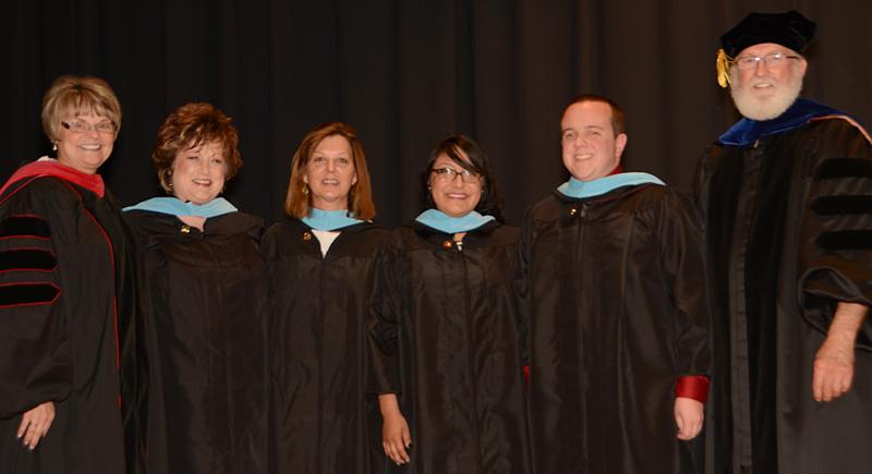 Dr. Kellie Cody, assistant professor of social work, and Dr. Darlene Eastridge, dean of the Carver School of Social Work and Counseling, pinned and hooding the Master's of Science in Counseling. From left - Cody, Cole Torbert, Daisy Perez, Lisa Nugent, Sharon Arflin and Eastridge. (Campbellsville University Photo by Drew Tucker)