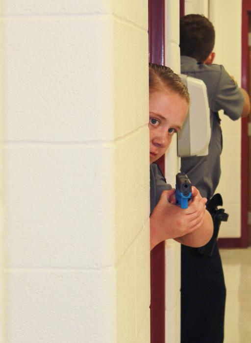 Makinsey Rogers from Louisville Metro Police Department Explorers is in shooting stance during a real- life shoot out Scenario. (Campbellsville University Photo by Joshua Williams)