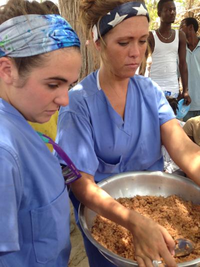 Michele Snipp, left, and Rachel Smith serve rice to children during children ministry and are concerned about the small amount of rice and large number of children to feed.