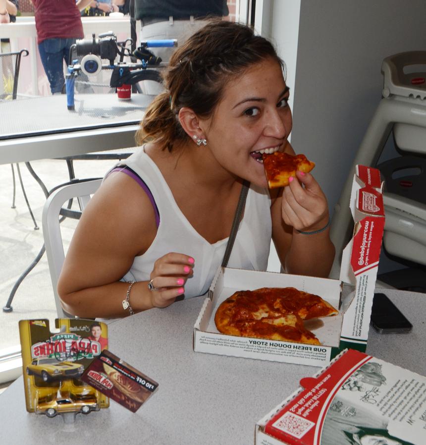 CU student Michelle Lomas enjoys some of the free pizza offered by Papa John's during the grand opening. (Campbellsville University Photo by Hanna Hall)