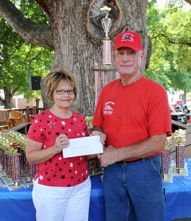 Paula Smith, right, director of alumni relations at Campbellsville University, accepts a $500 check for the university’s Scholarship Fund from Al Hardin, president of the Tri-County Car Club in Campbellsville. Those pursuing an auto-related career remain the club’s first priority, but if there are no applicants, the money will be given to the university to assist area students. There were no applicants this year for the annual scholarship. The Tri-County Car Club represents primarily Taylor, Adair and Green counties, with members from other counties as well. (Campbellsville University Photo by Stan McKinney)