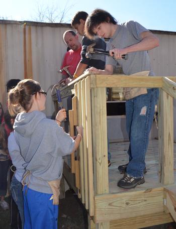 Freshmen Zach Wilson, top left, of Campbellsville,  Micheal Dowell, top middle, of Louisville, and Joey Smothers, bottom, of Lebanon, Ky., work on a  wheelchair ramp deck with Kentucky Heartland  Outreach and CU's Repair Affair. (CU Photo by Rachel Tingle)