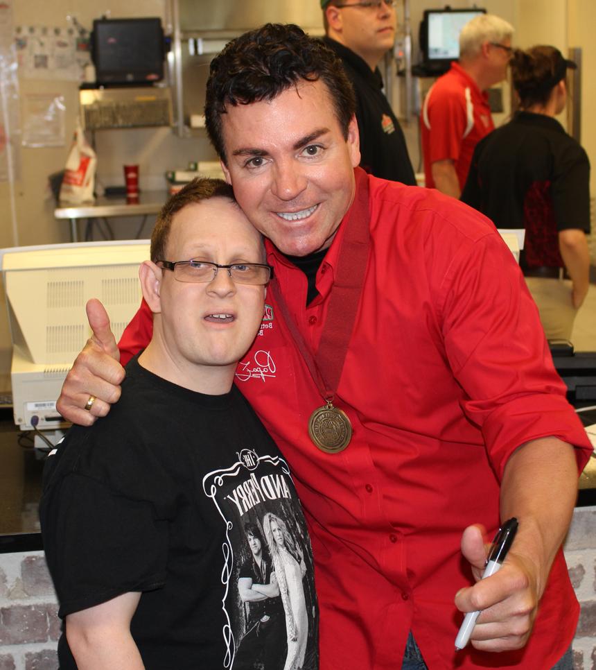 Sean Sprowles, an employee of Pioneer College Caterers Inc., right, poses with "Papa" John Schnatter during the grand opening of Papa John's Pizza on the campus of Campbellsville University. (Campbellsville University Photo by Drew Tucker)