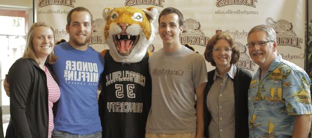  Aaron Smith, center, is coming to Campbellsville University in the fall. He is surrounded by CU alumni from left: Dave and Denise Gray Smith, his parents; Clawz, the Tiger mascot; Adam Smith, Dave and Denise's son, and Adam's wife, Kristina Critcher Smith. (Campbellsville University Photo by Robert Bender)