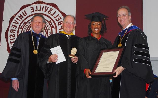 Shajuana Ditto of Brandenburg, Ky., second from left, receives the student Algernon Sydney Sullivan Award at Campbellsville University's undergraduate commencement. Making the presentation were from left: Dr. Michael V. Carter, president; Dr. Jay Conner, chair of the CU Board of Trustees; and Dr. Frank Cheatham, vice president for academic affairs. (Campbellsville University Photo by Joan C. McKinney)