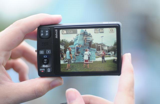 An onlooker photographs the world record-breaking stack of mattresses being built on Campbellsville University's Stapp Lawn during the Welcome Weekend festivities. (Campbellsville University Photo by André Tomaz)