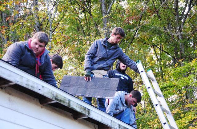 Students work on a repairing a roof at "Repair Affair" at Campbellsville University. (Campbellsville University Photo by Kasey Ricketts)