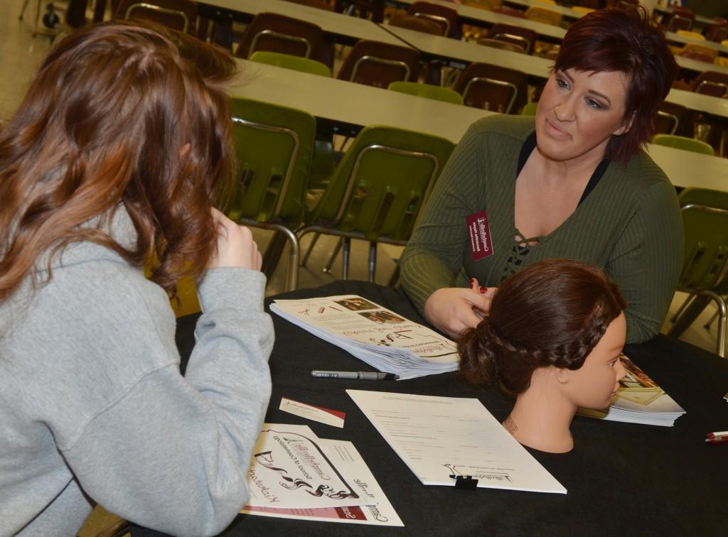 Samantha Hayes, an environment specialist at Campbellsville University, talks to CHS junior Jasmine Coomer about a career in cosmetology.