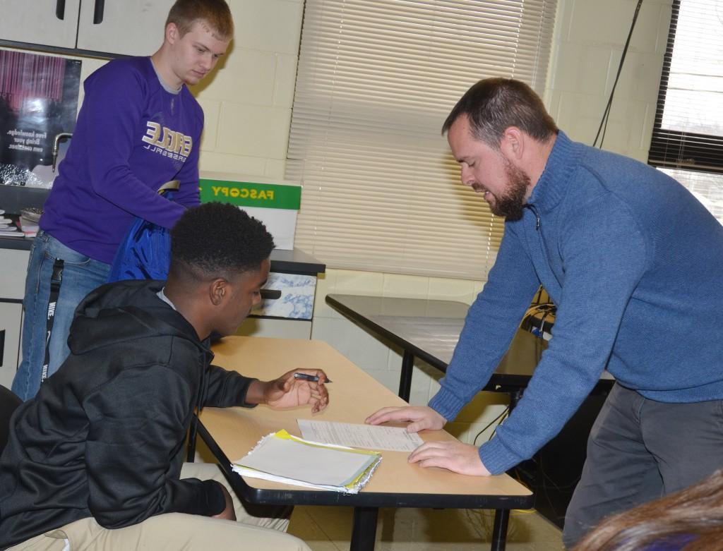 Scott Necessary, director of dual credit at CU, talks to CHS junior Chanson Atkinson about his dual credit application.