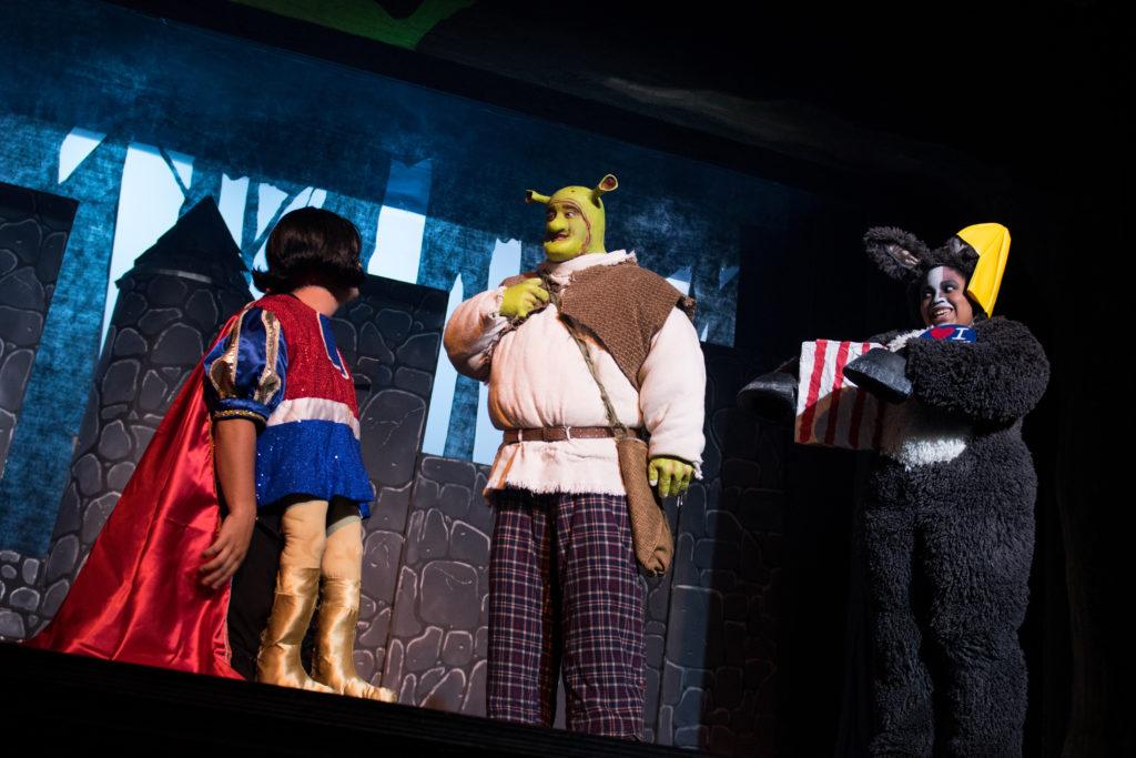 Lord Farquaad, played by Daniel Bannister of Glasgow Ky., orders Shrek, played by Marcus Stanfield of Campbellsville, Ky. and Donkey, played by Alica McClendon of Radcliff, Ky. to rescue the princess Fiona, played by Jenny Kawa of Greensburg, Ky., from dragon castle. (Campbellsville University Photo by Joshua Williams)