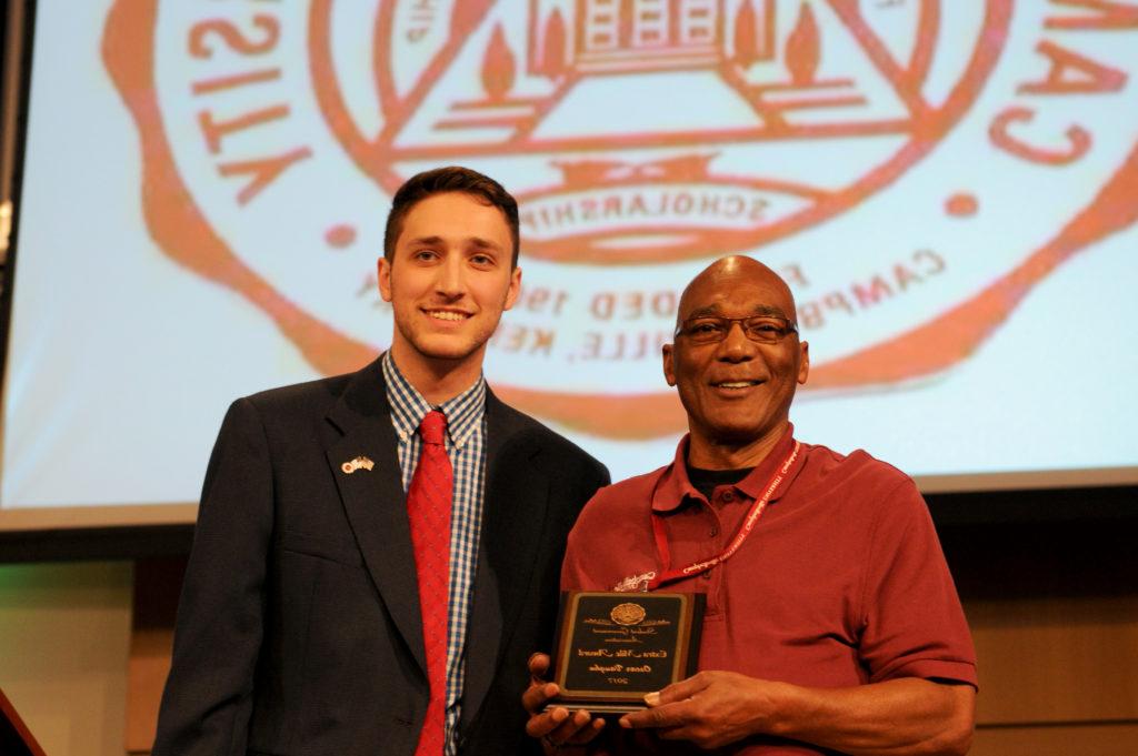 Aaron Nosich, president of Student Government Association, presents Oscar Vaughn, Powell Athletic Center's custodian, for the Extra Mile Award. (Campbellsville University Photo by Joshua Williams)