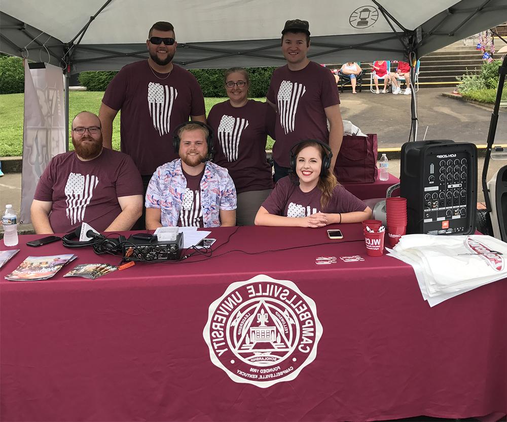 The Tiger Team at 88.7 FM covers the parade at 10 a.m. at the Campbellsville/Taylor County annual Fourth of July celebration. From left, front, are Jess McCandless of Elizabethtown, Ky.;  Alex Meade of Paintsville, Ky. and Andrew Bennett, coordinator of audio/visual services. Back, Matt Wehle of Mechanicsville, Va., Jeannie Clark, director of broadcast services, and Matt Payton, radio program/production director. (Campbellsville University Photo by Joan C. McKinney)