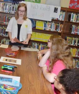 Keilah Coverstone, CU student, teaches CMS fourth-graders about Black Out poetry, which is created by “blacking out” words and letters contained in something already written to write something new. (Campbellsville Independent School photo by  Calen McKinney)