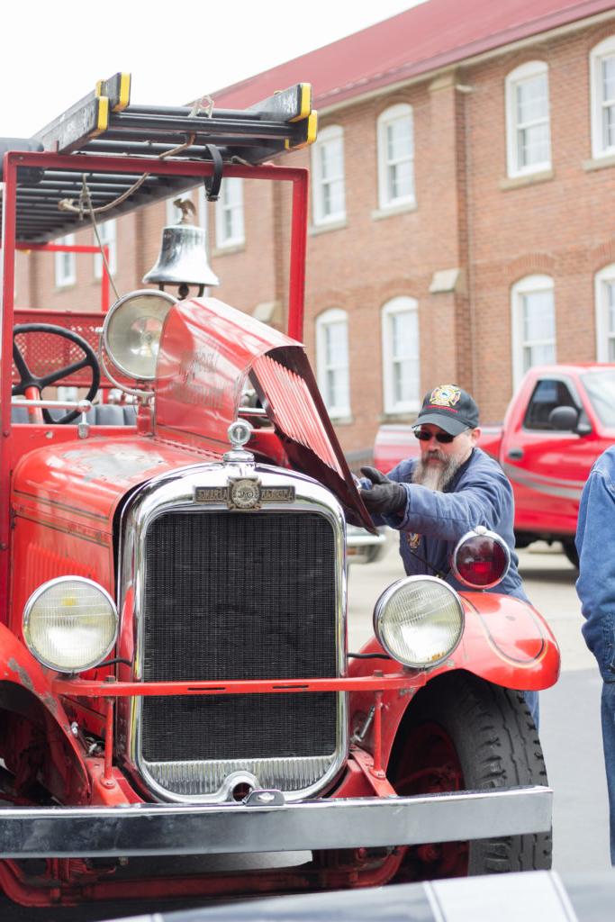 Randy Bricken Jr., shows off the engine of the 1932 fire truck during the Car Cruise at 2017 Homecoming at Campbellsville University. (Campbellsville University Photo by Joshua Williams)