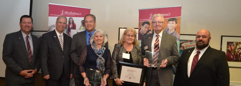 B.J. Senior, ('68), second from left, was awarded the Distinguished Alumnus Award at the Homecoming reception Friday night, Oct. 27. His wife, Vicki, was given an Honorary Alumnus Award. Debby Hazelip Duda ('82) and her husband, Dave ('77), were also given Distinguished Alumni Awards. Making the presentations were, from far left, Darryl Peavler, director of alumni relations; Dr. Michael V. Carter, president; and Benji Kelly, vice president for development. (Campbellsville University Photo by Joan C. McKinney)