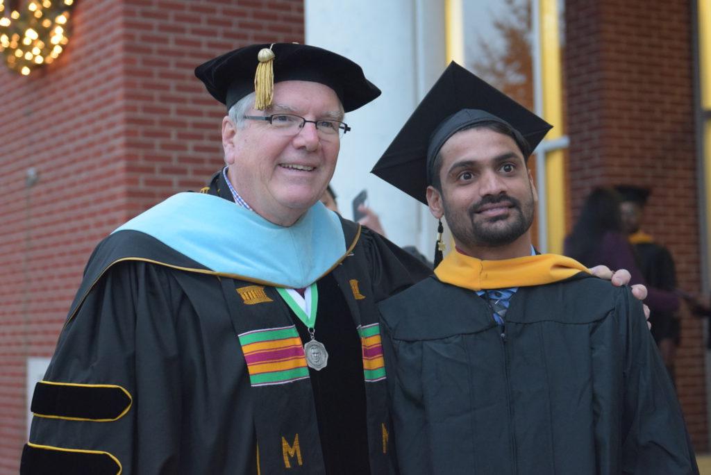 From left, Gangishetty Saikiran Goud of India takes a photo with Dr. H. Keith Spears, vice president for communications and assistant to the president, after his graduation ceremony at Campbellsville University. (Campbellsville University Photo by Andrea Burnside)