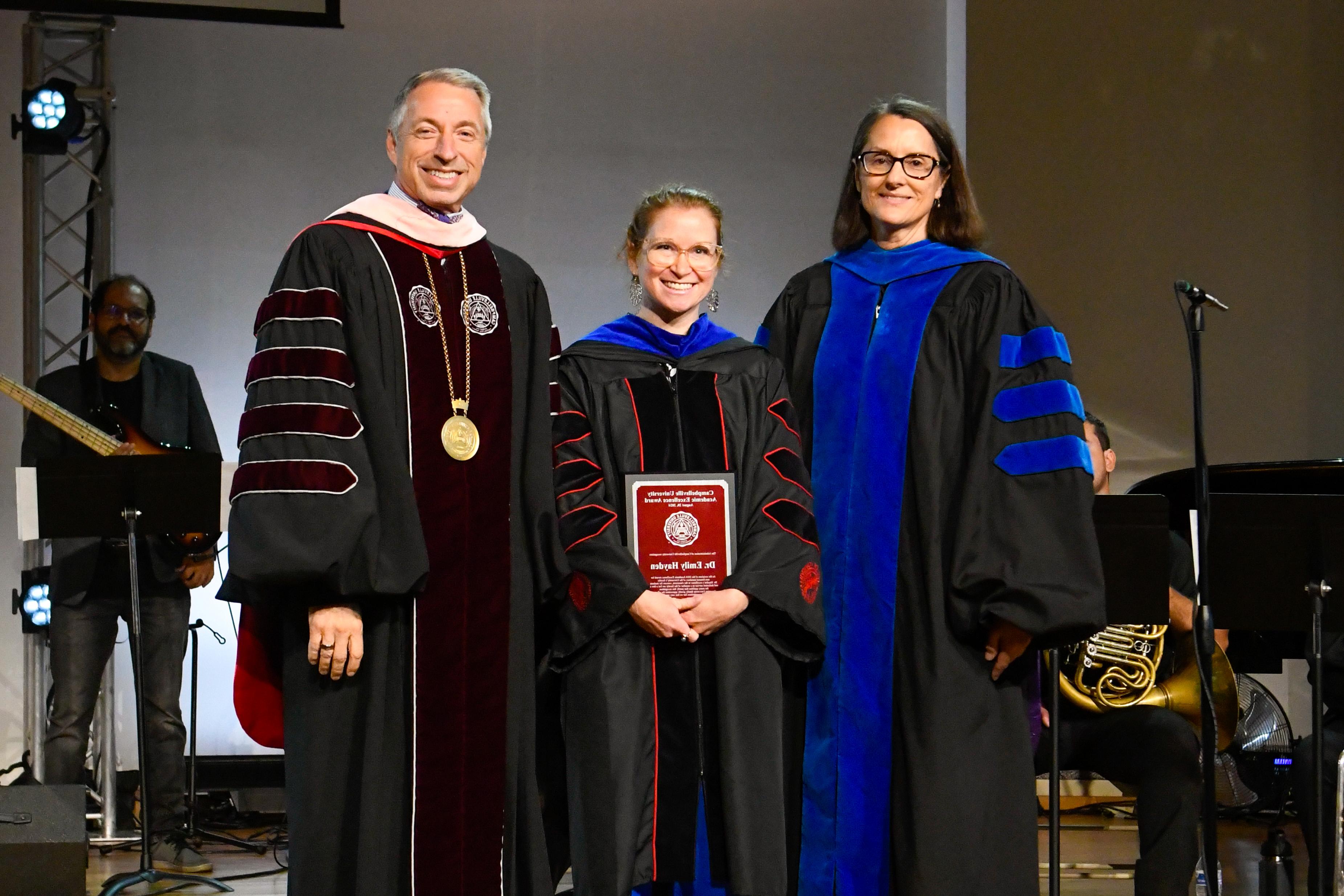 Dr. Emily Hayden, center, receives the 2024 CU Non-Tenured Faculty Award from Dr. Jeanette Parker, left, interim vice president for academic affairs, and CU President Dr. Joseph Hopkins.